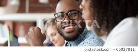 Diverse employees working in shared office focus on african guy 66027811