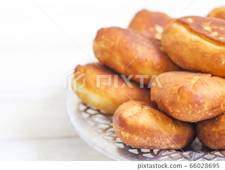 Piroshki - russian baked puff pastry with cabbage fillings. Traditional russian cabbage stuffed baked pastry. lean pies with cabbage. Beautiful homemade cakes with cabbage in metal dishes on white 66028695