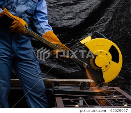 Worker grinding hollow structural steel with Worker grinding hollow structural steel with 66029037