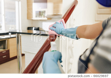 Housewife wiping staircase railing Housewife wiping staircase railing 66029697