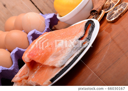 fresh salmon fillet close up on white plate. eggs, fresh salmon fillet close up on white plate. eggs, 66030167