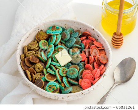 Colorful pancake cereal in baby hands 66031261