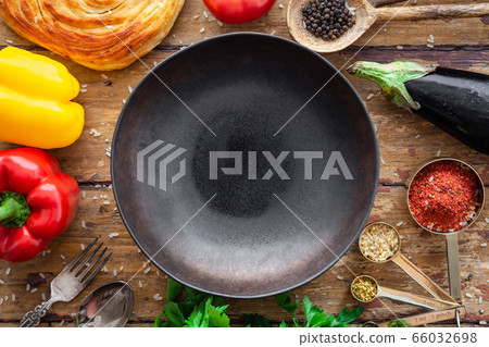 Pilaf ingredients, rice, vegetables, pita, cutlery, spices on rustic background 66032698