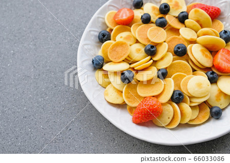 Freshly cooked pancake cereal served with fresh berries. Freshly cooked pancake cereal served with fresh berries. 66033086