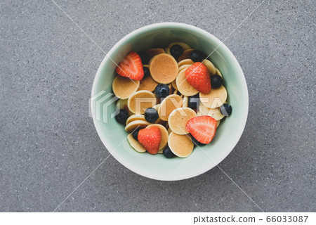 Freshly cooked pancake cereal in a bowl served with berries. Freshly cooked pancake cereal in a bowl served with berries. 66033087