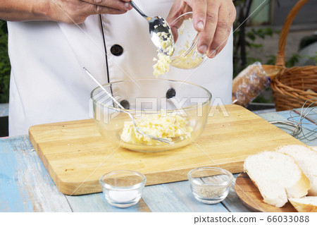 Chef putting minced garlic to bowl for cook garlic Chef putting minced garlic to bowl for cook garlic 66033088