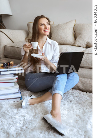 Young student watching lesson online and studying from home. Girl student studying from home Young student watching lesson online and studying from home. Girl student studying from home 66034015