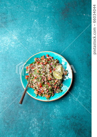 Traditional Lebanese salad tabouli tabule with quinoa, herbs, tomatoes, mint and lemon Traditional Lebanese salad tabouli tabule with quinoa, herbs, tomatoes, mint and lemon 66034044