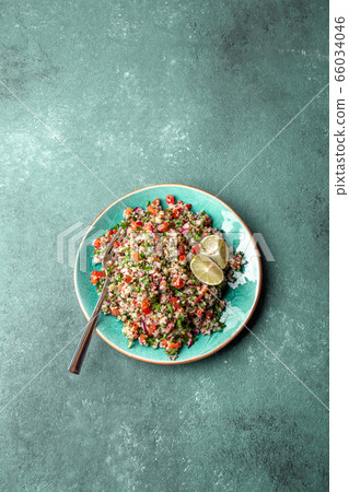 Traditional Lebanese salad tabouli tabule with quinoa, herbs, tomatoes, mint and lemon 66034046