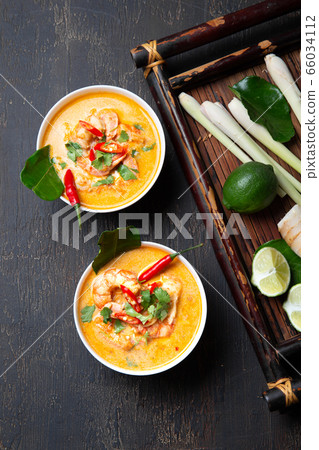 Shrimps Tom Yam Kung in white bowls, top view, wooden background. Shrimps Tom Yam Kung in white bowls, top view, wooden background. 66034112