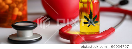 On table is bottle hemp oil and jar capsules On table is bottle hemp oil and jar capsules 66034797