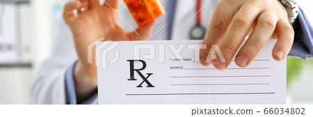 Male medicine doctor hand hold jar of pills 66034802