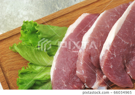 raw pork steak - pork neck - with lettuce leaves raw pork steak - pork neck - with lettuce leaves 66034965