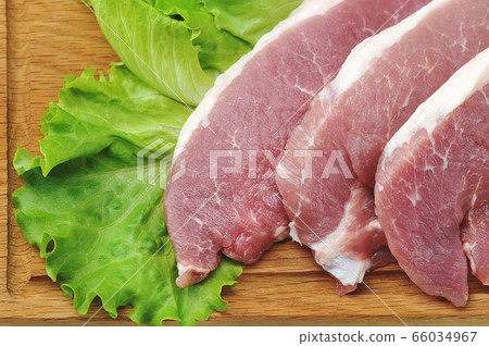 raw pork steak - pork neck - with lettuce leaves 66034967
