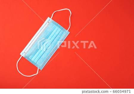 blue protective mask on a red background blue protective mask on a red background 66034971