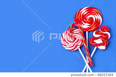 Colorful lollipop on blue background 66035364