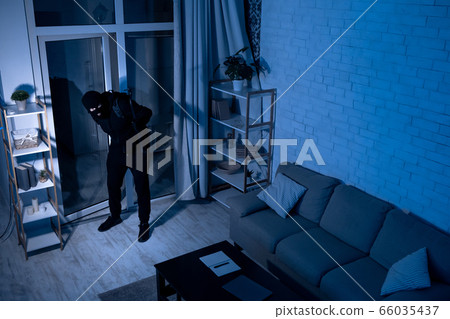 Thief With Crowbar Entering House View From Camera 66035437