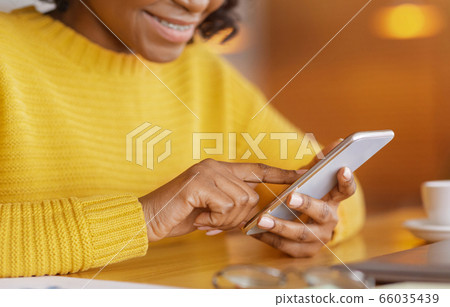 Cropped of black lady using mobile phone 66035439