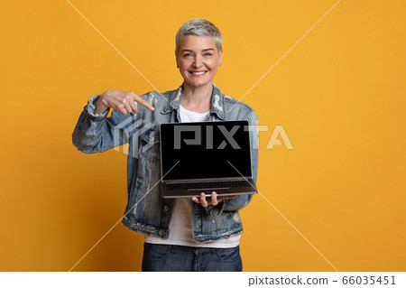 Freelance Websites. Positive Middle-Aged Woman Pointing At Laptop With Black Screen 66035451
