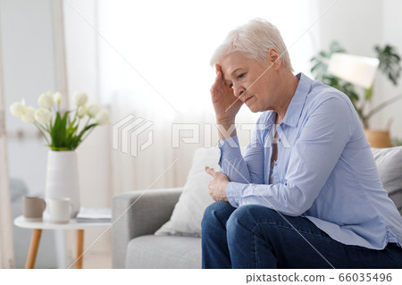 Woman Climax. Portrait Of Depressed Elderly Woman Sitting On Couch At Home Woman Climax. Portrait Of Depressed Elderly Woman Sitting On Couch At Home 66035496