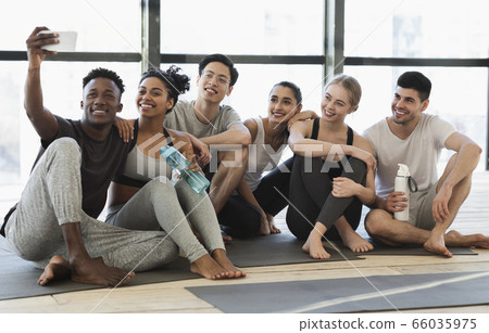 Happy multicultural friends taking selfie on smartphone after fitness training 66035975