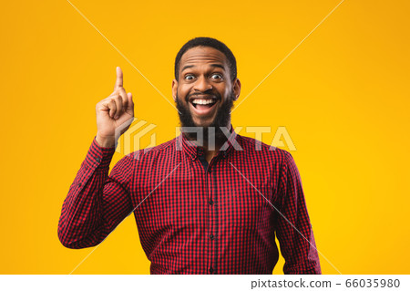 Excited black guy has great idea and points up Excited black guy has great idea and points up 66035980