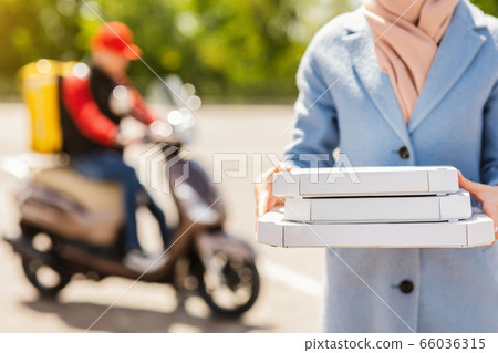 Unrecognizable Woman Holding Pizza Boxes Receiving Food From Courier Outdoor 66036315