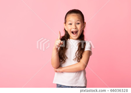 Excited asian girl has great idea and points up Excited asian girl has great idea and points up 66036328