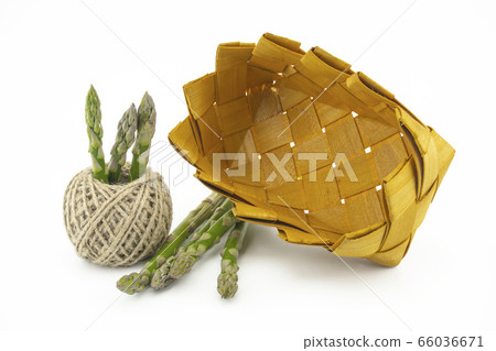 Fresh green asparagus in a rustic woven basket Fresh green asparagus in a rustic woven basket 66036671