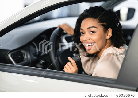 Lady Buyer Showing Auto Key Sitting In Automobile In Dealership 66036676