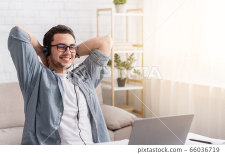 Online webinar and remote work. Man in headset with laptop at home 66036719