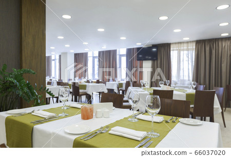 Tableware in hotel restaurant. Room with luminous lit 66037020