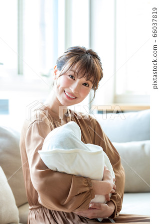 Mom holding an infant Mom holding an infant 66037819