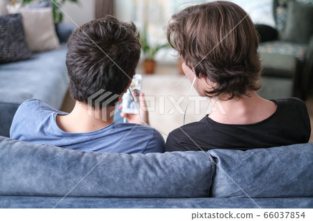 Two brothers are video chatting on smart phone Two brothers are video chatting on smart phone 66037854