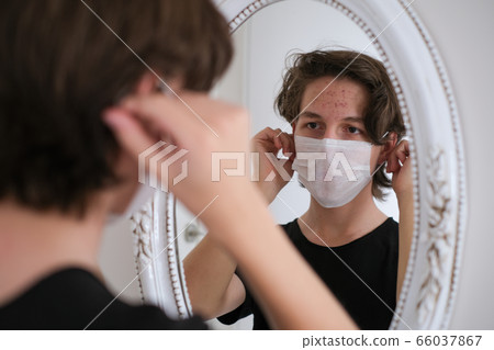 Caucasian teenager  wears protective medical mask 66037867
