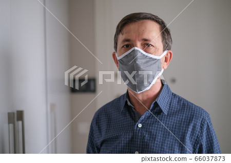 Middle-aged man wears face mask in the Coronavirus 66037873