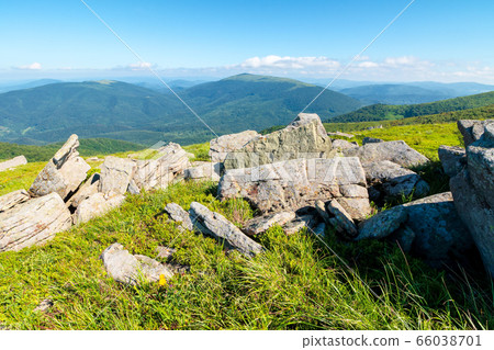 row of huge rocks on a grassy hill. lovely summer 66038701