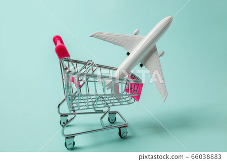 Toy plane and shopping push cart on blue 66038883
