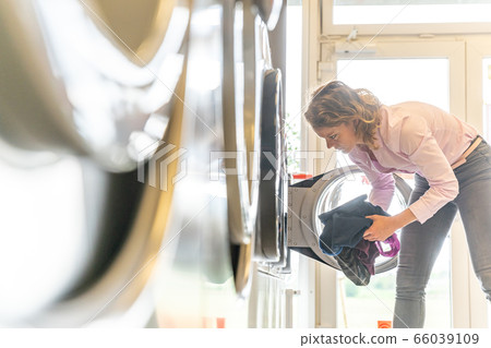 woman uses a public laundry. copy space 66039109