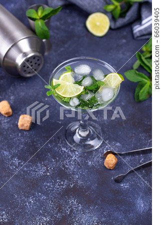 Martini cocktail with lime and mint. Martini cocktail with lime and mint. 66039405