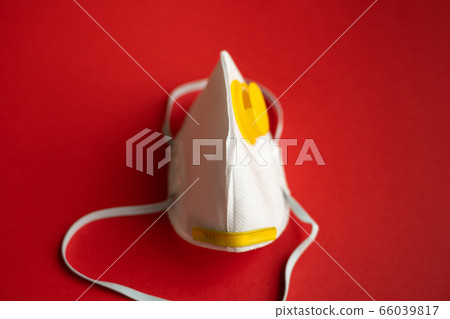 Respirator mask FFP or dust mask to cover the mouth and nose prevent coronavirus isolated on red background. Breathing protection against air pollution, flu and coronavirus. 66039817