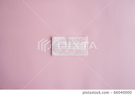 Used pink medical mask on a pink background. Disposable 3-ply medical mask to cover the mouth and nose to prevent coronavirus. Coronavirus quarantine. Antivirus medical mask for protection covid-19. Used pink medical mask on a pink background. Disposable 3-ply medical mask to cover the mouth and nose to prevent coronavirus. Coronavirus quarantine. Antivirus medical mask for protection covid-19. 66040000