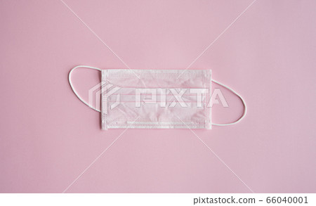 Used pink medical mask on a pink background. Disposable 3-ply medical mask to cover the mouth and nose to prevent coronavirus. Coronavirus quarantine. Antivirus medical mask for protection covid-19. Used pink medical mask on a pink background. Disposable 3-ply medical mask to cover the mouth and nose to prevent coronavirus. Coronavirus quarantine. Antivirus medical mask for protection covid-19. 66040001