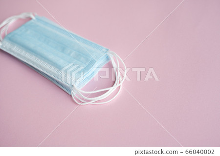 Medical protective masks on a pink background. Disposable 3-ply medical mask to cover the mouth and nose to prevent coronavirus. Coronavirus quarantine. Antivirus medical mask for protection covid-19. Medical protective masks on a pink background. Disposable 3-ply medical mask to cover the mouth and nose to prevent coronavirus. Coronavirus quarantine. Antivirus medical mask for protection covid-19. 66040002