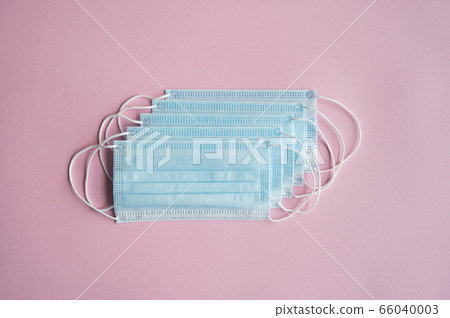 Medical protective masks on a pink background. Disposable 3-ply medical mask to cover the mouth and nose to prevent coronavirus. Coronavirus quarantine. Antivirus medical mask for protection covid-19. Medical protective masks on a pink background. Disposable 3-ply medical mask to cover the mouth and nose to prevent coronavirus. Coronavirus quarantine. Antivirus medical mask for protection covid-19. 66040003