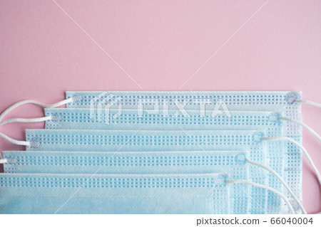 Medical protective masks on a pink background. Disposable 3-ply medical mask to cover the mouth and nose to prevent coronavirus. Coronavirus quarantine. Antivirus medical mask for protection covid-19. Medical protective masks on a pink background. Disposable 3-ply medical mask to cover the mouth and nose to prevent coronavirus. Coronavirus quarantine. Antivirus medical mask for protection covid-19. 66040004