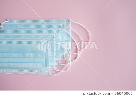 Medical protective masks on a pink background. Disposable 3-ply medical mask to cover the mouth and nose to prevent coronavirus. Coronavirus quarantine. Antivirus medical mask for protection covid-19. Medical protective masks on a pink background. Disposable 3-ply medical mask to cover the mouth and nose to prevent coronavirus. Coronavirus quarantine. Antivirus medical mask for protection covid-19. 66040005
