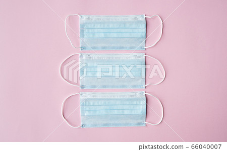 Medical protective masks on a pink background. Disposable 3-ply medical mask to cover the mouth and nose to prevent coronavirus. Coronavirus quarantine. Antivirus medical mask for protection covid-19. Medical protective masks on a pink background. Disposable 3-ply medical mask to cover the mouth and nose to prevent coronavirus. Coronavirus quarantine. Antivirus medical mask for protection covid-19. 66040007