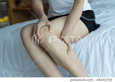 women lag pain on bed in bed room in the morning. 66040706