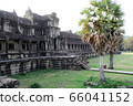 Tourist couple cycling around Angkor temple, Cambodia. Ta Keo building ruins in the jungle. Eco friendly tourism traveling, toned image. 66041152